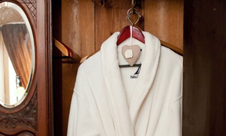 A bathrobe in a closet